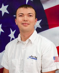 plumber in white shirt in front of American flag